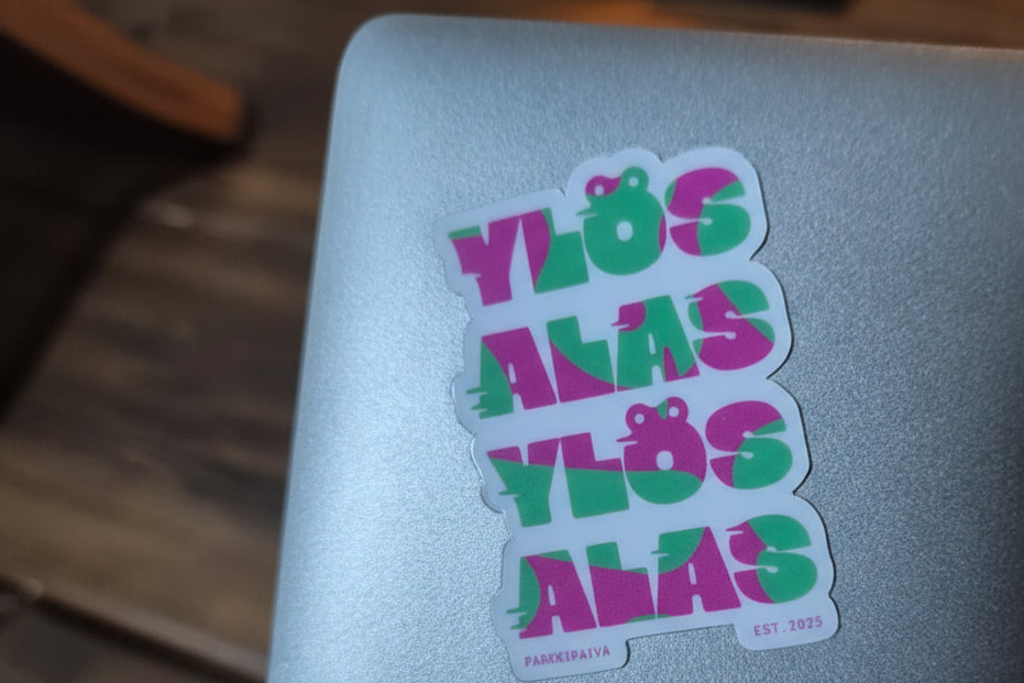 Ylos Alas Sticker on silver laptop